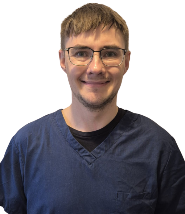 Mark Pearce wearing navy blue scrubs